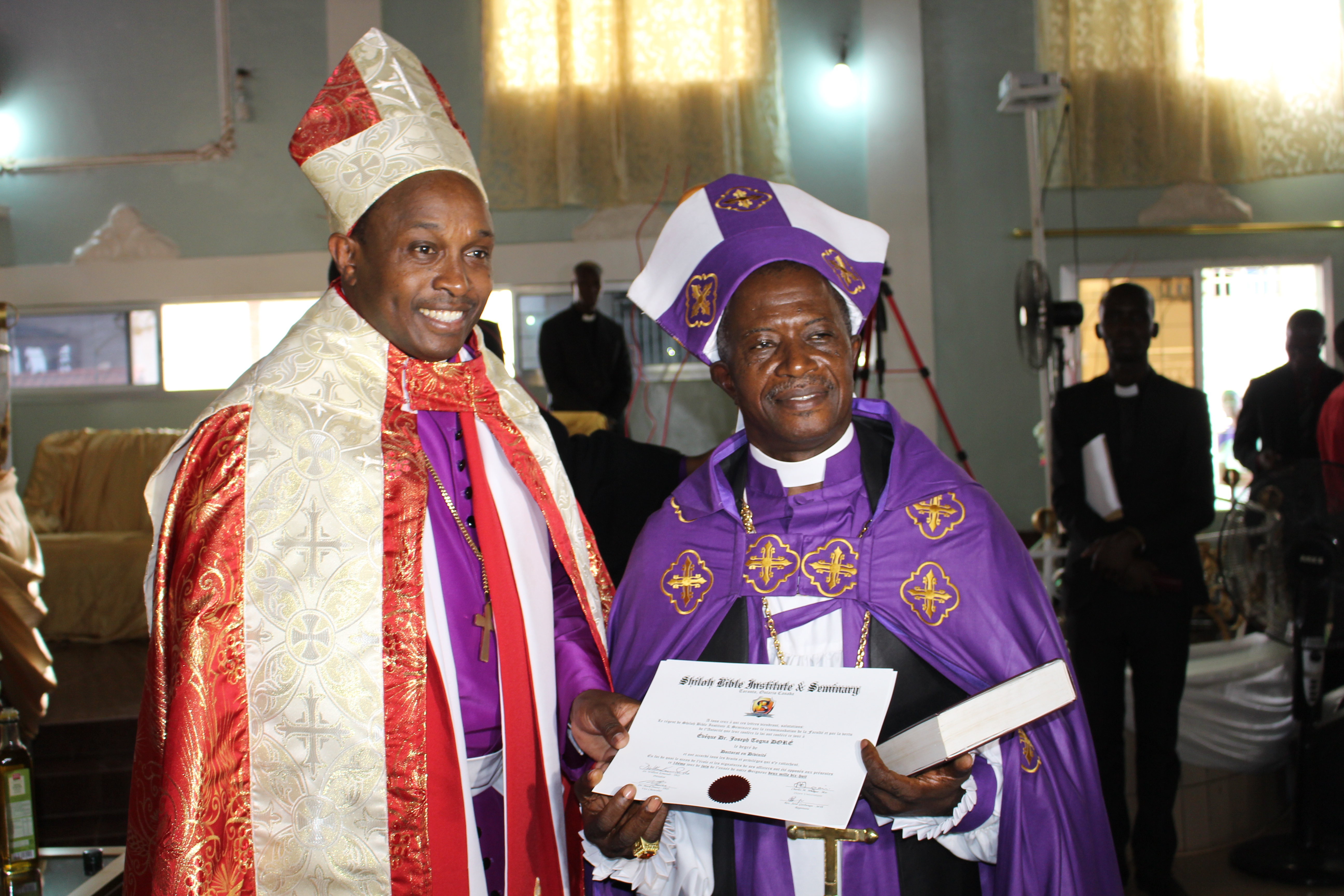Archbishop William Kimando presenting Consecration certificate to Bishop Dr. Dore